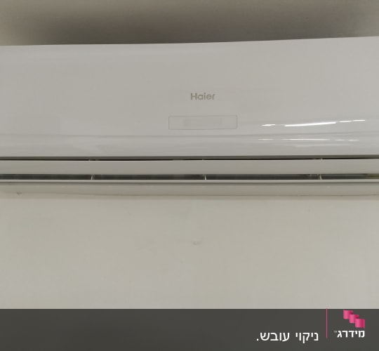 מזגן קיר לבן מותקן על קיר